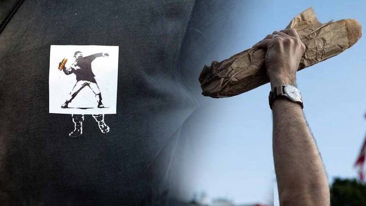 Direnişin yeni sembolü: Banksy'nin "Çiçek Fırlatan Adam"ı "Sandviç Adam"a dönüştü! Protesto gösterilerinde artık sandviç tutuyorlar